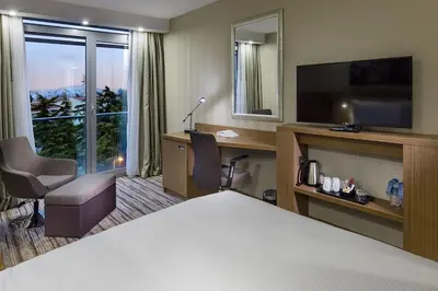 a hotel room with a bed and a large window at Hampton by Hilton Istanbul Atakoy in Istanbul