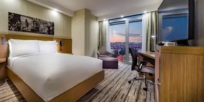 a hotel room with a bed and a desk and a computer at Hampton by Hilton Istanbul Atakoy in Istanbul