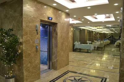 a restaurant with tables and chairs in a room at Görükle Güler Park Hotel in Gorukle