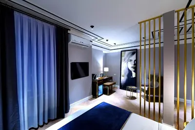 a bedroom with a bed and a desk at Walton Hotels Galata in Istanbul