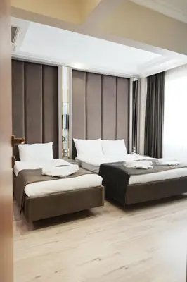 a hotel room with two beds and a window at Reyyan Hotel in Istanbul