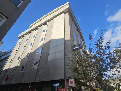 a tall building with a sign on the side of it at Pasa Hotel Gemlik in Gemlik