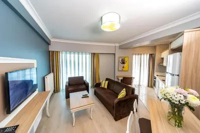 a living room with a couch and a table at Serenity Suites Istanbul Airport in Istanbul