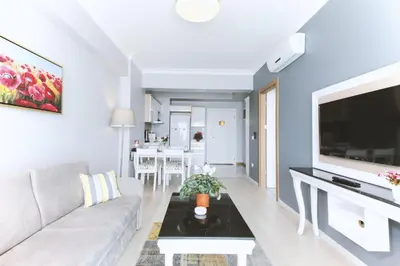 a living room with a couch and a tv at Serenity Suites Istanbul Airport in Istanbul