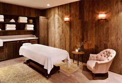 a massage room with a bed and a chair at Soho House Istanbul in Istanbul