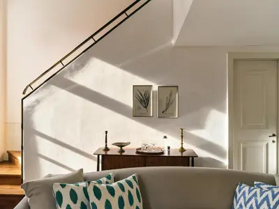 a living room with a couch and a white wall at Soho House Istanbul in Istanbul