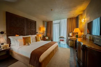 a hotel room with a large bed and a television at Soho House Istanbul in Istanbul