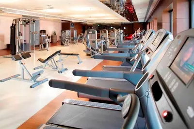 a gym with a row of cardio machines at Istanbul Marriott Hotel Asia in Istanbul
