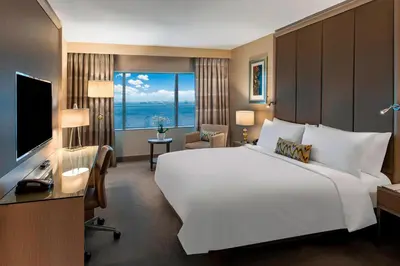 a bedroom with a large white bed and a large window at Renaissance Polat Istanbul Hotel in Istanbul