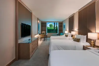 a hotel room with two beds and a flat screen tv at Renaissance Polat Istanbul Hotel in Istanbul
