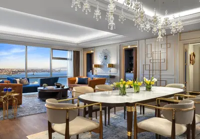 a living room with a table and chairs at The Ritz-Carlton, Istanbul at the Bosphorus in Istanbul