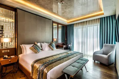 a hotel room with a large bed and a chair at Arise Hotel Golden Horn in Istanbul