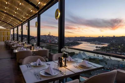 a restaurant with tables and chairs and a view of a river at Arise Hotel Golden Horn in Istanbul