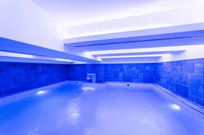 a large swimming pool with blue tiled walls and ceilings at The Hotel Beyaz Saray Old City in Istanbul
