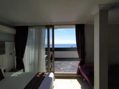 a bedroom with a bed and a view of the ocean at Ceti̇n Presti̇ge Resort in Erdek
