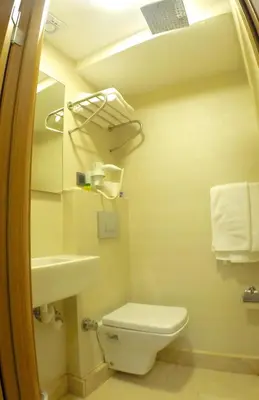 a bathroom with a toilet and a sink and a mirror at Okur Otel in Istanbul