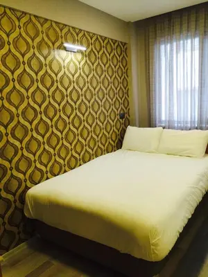 a bedroom with a large bed with a wall at Okur Otel in Istanbul