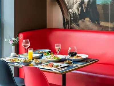 a table with plates of food and glasses of wine at Ibis Istanbul West in Istanbul