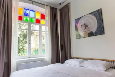 a bedroom with a bed and a window with a rainbow at Serguzest Otel in Buyukada