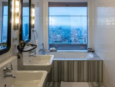 a bathroom with a tub and a sink and a window at The Cettia Istanbul in Istanbul