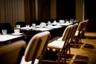 a long table with chairs and glasses on it at The Cettia Istanbul in Istanbul
