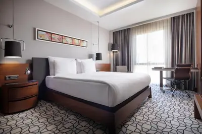 a hotel room with a large bed and a desk at Grand Harilton Otel in Istanbul
