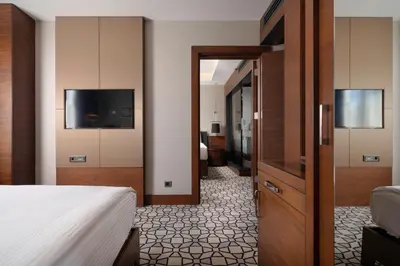 a hotel room with a bed and a television at Grand Harilton Otel in Istanbul