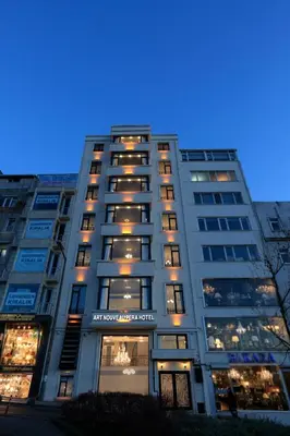 a tall building with many windows at night at Art Nouveau Pera in Istanbul