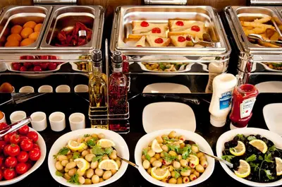 a buffet with plates of food and bowls of food at Vali Konak Hotel Nişantaşı in Istanbul