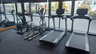a row of exercise bikes and treadmills in a gym at Nearport Hotel Sabiha Gokcen Airport in Istanbul