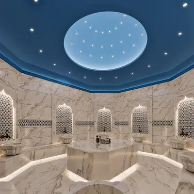a white room with a blue ceiling and a table at Grand Cevahir Hotel Convention Center in Istanbul