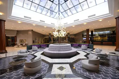 a lobby with a large fountain in the middle at Grand Cevahir Hotel Convention Center in Istanbul