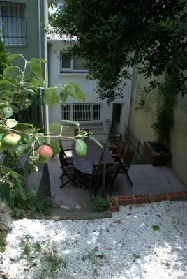 a patio with a table and chairs in front of a house at Inin Bebek in Istanbul