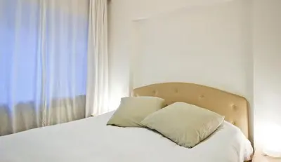 a white bed with two pillows on top of it at Inin Bebek in Istanbul
