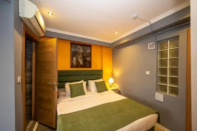 a bedroom with a bed with green and yellow walls at Marida Suit - Istanbul Taksim in Istanbul