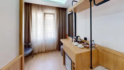 a bathroom with a vanity with a sink and a mirror at Istanbul River Hotel in Istanbul