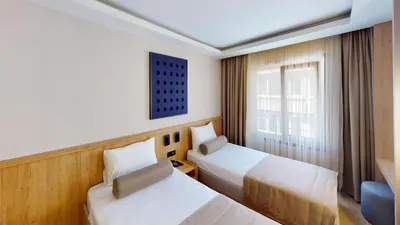 a hotel room with two beds and a window at Istanbul River Hotel in Istanbul