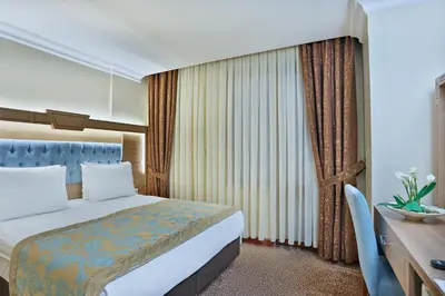a hotel room with a bed and a desk at Budo Hotel in Istanbul