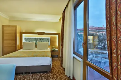 a hotel room with a bed and a large window at Budo Hotel in Istanbul