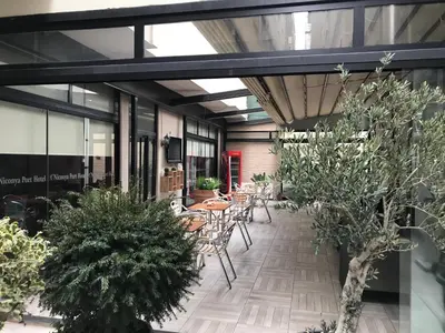 a patio with tables and chairs and plants at Niconya Port Suite&Hotel in Istanbul