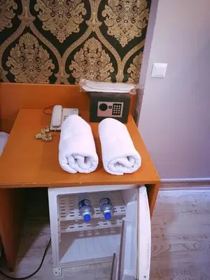 a table with two towels and a phone on it at Masal Otel in Kocaeli