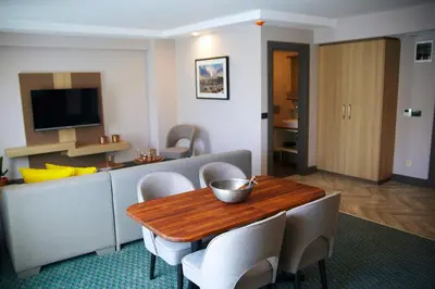 a living room with a wooden table and chairs at Tophane Suites in Istanbul