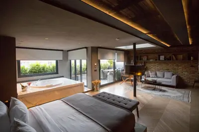 a bedroom with a large bed and a bath tub at Cityloft 81 in Istanbul