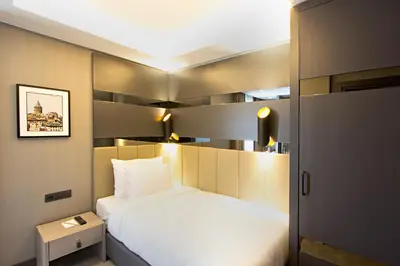 a bedroom with a large white bed and a door at Cityloft 81 in Istanbul