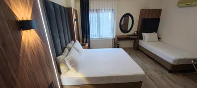 a small room with two beds and a mirror at Star Hotel in Istanbul