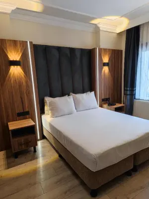 a bedroom with a large bed and two lamps at Star Hotel in Istanbul