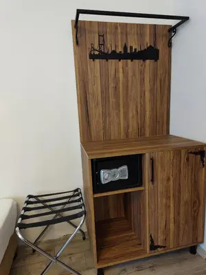 a wooden cabinet with a shelf and a chair in a room at Star Hotel in Istanbul