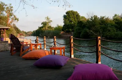 three purple and orange pillows sitting on a wooden dock at Agva Nehir Evi - Adult Only in Agva
