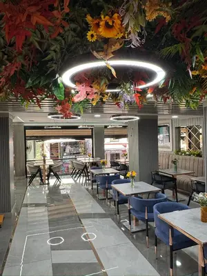 a restaurant with tables and chairs and flowers on the ceiling at Best Nobel Hotel in Istanbul