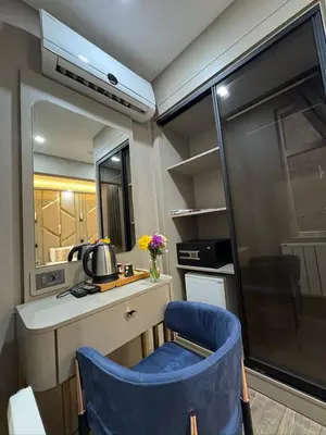 a small kitchen with a blue chair in a room at Best Nobel Hotel in Istanbul